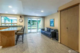 The kitchen peninsula and dining room. The covered patio is seen out the sliding   glass doors.