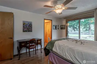 The primary bedroom has a patio door out to the river.