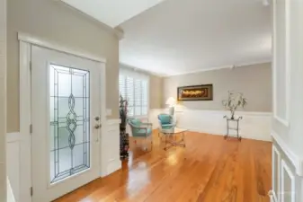 The beautiful stained glass entry welcomes you and opens to a spacious living room. Stunning hardwood floors throughout the main floor. Crown molding and detailed mill work.