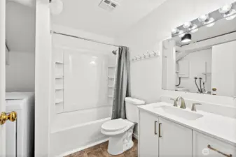 Spacious lower-level bathroom complete with laundry machines for added convenience
