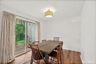 Bright dining area with abundant natural light and a sliding door that opens to the deck—perfect for indoor-outdoor living.