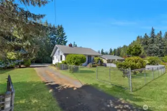 Welcome home! Gated entry plus fully enclosed  fenced front yard! This charming home is situated on an open sunny lot plus an added .59 acre to make .98 acre!
