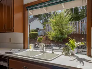 This large picture window is a focalpoint in this kitchen and continues to let the amazing light into this home.