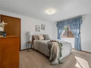 The second bedroom also has a large window with a view into the backyard.
