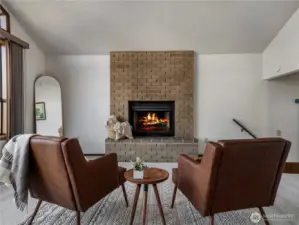 The family room has a cozy stone fireplace.