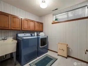 The large laundry room is located downstairs, and there is also a half bathroom located here.