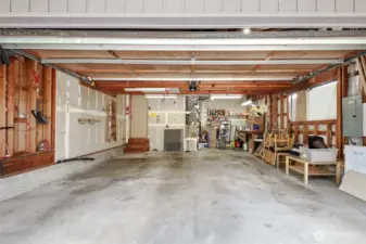 Two car garage with ample storage and work space.