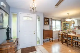 Front entry with tile and cute crystal chandelier