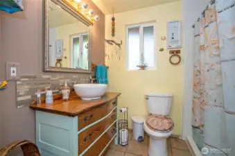 Main bath with cute vanity. This is a 3/4 bath