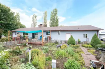 Back yard view showing the English Garden. It is beautiful in the springtime and summer