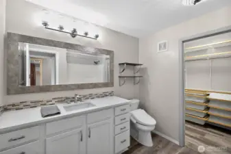 Primary ensuite bathroom with walk-in closet