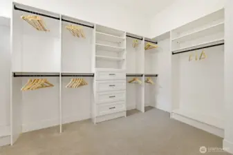 Just one of the two closets the primary suite has to offer