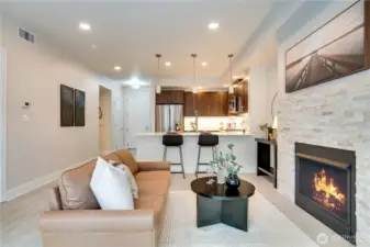Welcome to your new home! This modern living room seamlessly opens to the kitchen, creating a bright, open-concept space perfect for entertaining and everyday living.