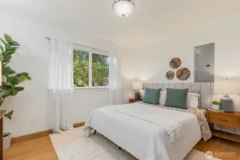 Primary bedroom with views of the front yard.
