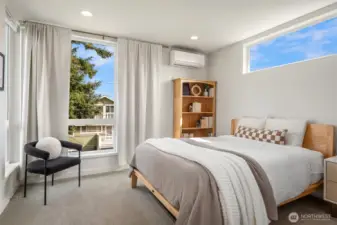 The top-floor primary suite feels like a proper retreat with great natural light, downtown views, and a spa-like bath with a walk-in rain shower.