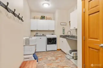 Utility room with utility sink, additional storage closets and cabinets