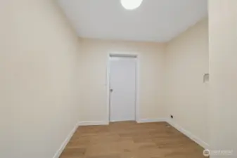 Large laundry room with door to back.