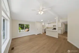 Very well lite family room just off the kitchen- lots of natural lighting, vaulted ceilings, new LVP flooring make this the room everyone wants to be in.
