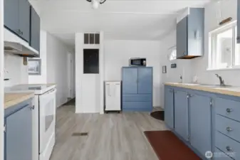 Super cute kitchen. The roll away island is great for additional storage and prep space.