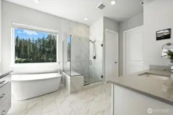 Walk-in shower with tile bench and frameless glass