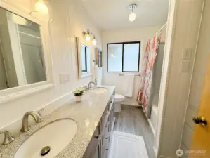Beautiful bathroom on the main floor has both a shower and a tub plus two sinks