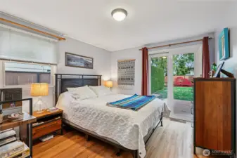 Bedroom one.  See the original hardwoods throughout.  There's also access to the backyard from this bedroom.
