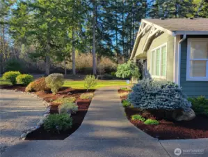 Thoughtfully landscaped grounds accentuate this beautiful walkway.