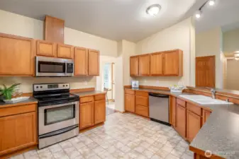 Beautiful hardwood cabinets and tiled flooring offer both classic style and everyday practicality.