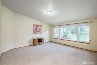 Large living room great for gatherings with a great view of the backyard.