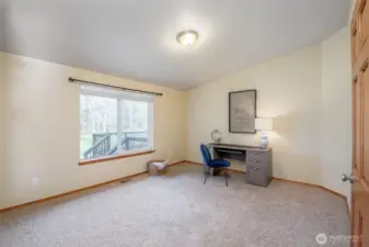 Office settled next to living room creates a nook of privacy with great space of storage or alternative uses.