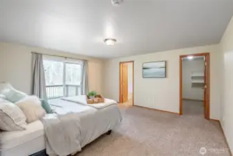 Primary room paired with a sizable walk-in closet and attached full bathroom.
