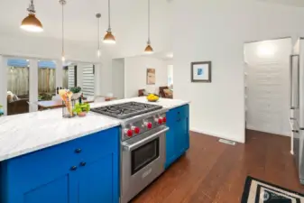 Bright kitchen with Carrera marble counters, Wolf Gas Range, stainless appliances, walk in pantry.... a wonderful entertainers kitchen and dining area!