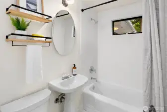 Updated full bathroom on main floor between bedrooms., features heated floors.