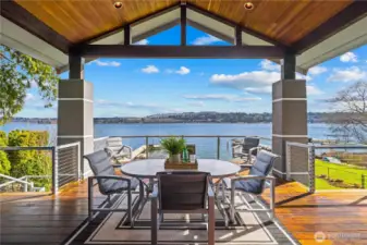Covered waterfront deck designed for year-round living—dining, relaxing, and taking in uninterrupted lake views.