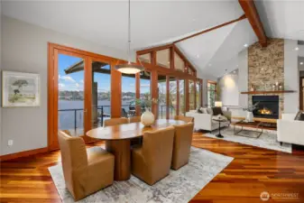 Open-concept living and dining with walls of glass, vaulted ceilings, and seamless access to the waterfront deck.