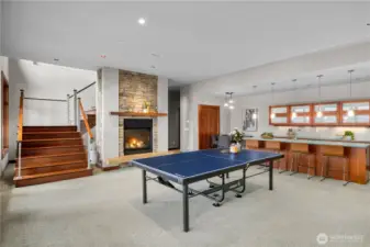 Architectural stairway serves as a focal point, linking this inviting lower level to the heart of the home