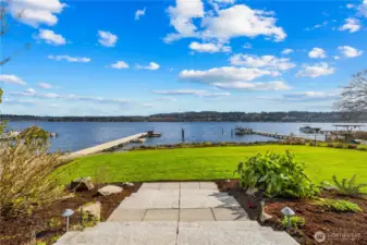 Lush, level waterfront lawn with private dock and wide-open lake views. Professionally landscaped beds and pathway lighting lead down to the water's edge—ideal for entertaining, kayaking, or simply enjoying the Pacific Northwest lifestyle