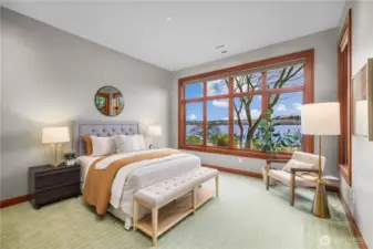 A peaceful retreat framed by the lake—this light-filled bedroom offers front-row views of the water, where mornings begin softly and evenings wind down in quiet, natural beauty.