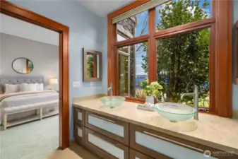 A seamless extension of the suite, this spa-inspired bath pairs sculptural glass vanities with serene garden and water views—bringing light, privacy, and a sense of calm to everyday routines.