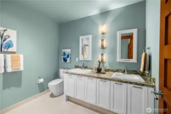 A bright and beautifully appointed shared bath with double vanities—perfect for busy mornings and easy everyday living.