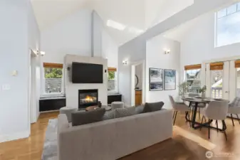 Living and dining area with vaulted ceilings and natural light.