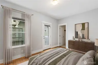 Private second bedroom suite with clawfoot soaking tub, walk-in closet, and access to a small outdoor deck.