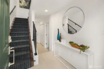 Custom runners up the stairs.  Two car garage is through the door straight ahead.