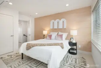 Second ensuite bedroom on the top floor with shiek grass cloth wall covering.