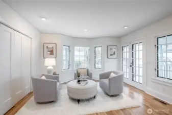 Full of windows, this bright corner of the family room leads out to the covered deck
