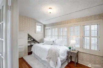 Enjoy built-in drawers and a pull down desk in this light filled room