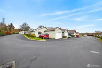 Convenient designated parking sits adjacent to the garage, complemented by additional guest parking within the community.