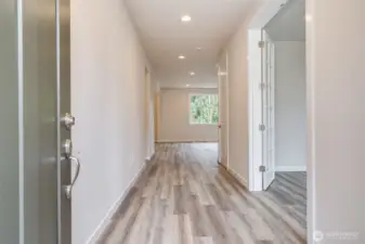 Photo not from actual home. Front door opens to wide entry