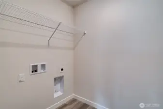 Photo not from actual home. Laundry room