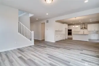 Photo not from actual home. Great room flows into kitchen